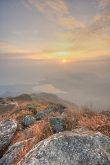 Image showing mountain sunset and colored sky with clouds 