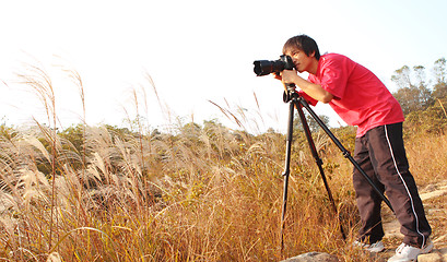 Image showing photographer taking photo in country side 