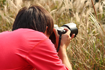 Image showing photographer taking photo in country side 