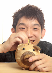 Image showing asia man with piggy bank 