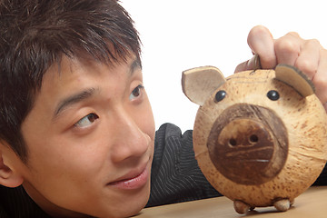 Image showing asia man with piggy bank 