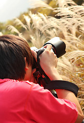 Image showing photographer taking photo in country side 
