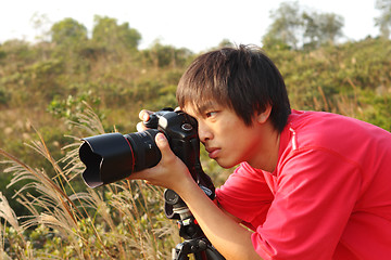 Image showing photographer taking photo in country side 