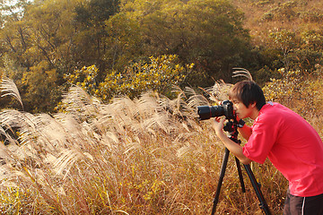 Image showing photographer taking photo in country side 