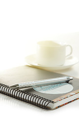 Image showing Pen on a white paper with cup of coffee