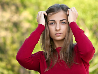 Image showing beautiful girl in a red jacket