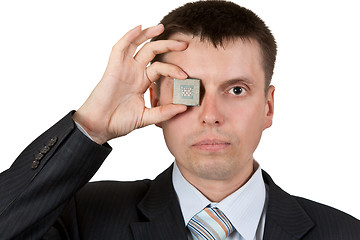 Image showing Businessman closes one eye, a processor
