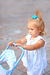 Image showing Girl with toy pram