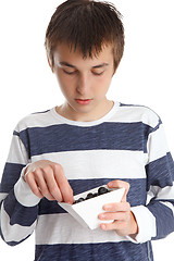 Image showing Child eating blueberries