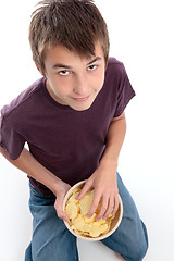 Image showing Boy eating potato chips