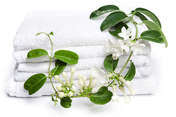 Image showing White towels  with white flowers for wellness 