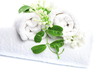 Image showing White towels  with white flowers for wellness 