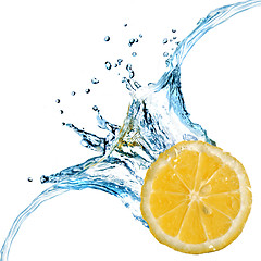 Image showing Fresh lemon dropped into water with splash isolated on white