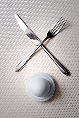 Image showing One egg with crossed knife and fork