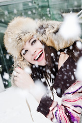 Image showing smiling young woman in falling snow