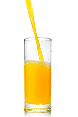 Image showing orange juice poring into glass isolated on white