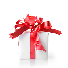 Image showing Holiday gift with red ribbon isolated on white