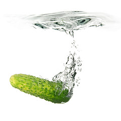 Image showing green cucumber dropped into water isolated on white