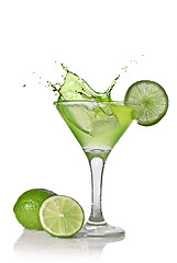 Image showing Green alcohol cocktail with splash and green lime isolated on wh