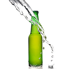 Image showing Green beer bottle with water splash isolated on white