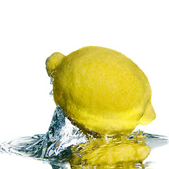 Image showing Fresh lemon on water with bubbles isolated on white