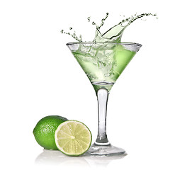 Image showing Green alcohol cocktail with splash and green lime isolated on wh