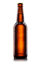 Image showing Beer bottle with water drops isolated on white