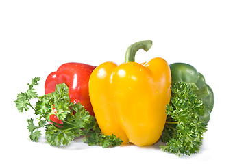 Image showing red, yellow and green pepper with parsley isolated on white