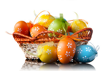 Image showing color easter eggs in basket isolated on white