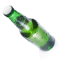 Image showing Green beer bottle with water drops isolated on white