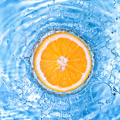 Image showing Fresh orange dropped into water with bubbles isolated on white