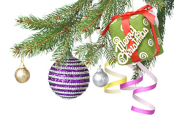 Image showing Christmas balls, gift and decoration on fir tree branch isolated