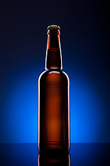 Image showing Beer bottle on blue background