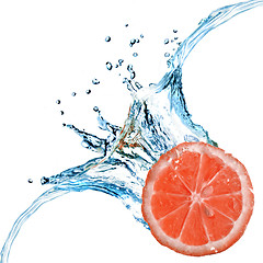 Image showing Fresh grapefruit dropped into water with bubbles isolated on whi