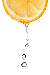 Image showing Fresh orange slice with water drops isolated on white