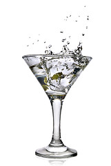 Image showing martini with olives and splash isolated on white