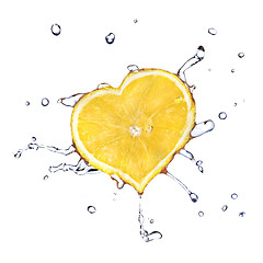 Image showing heart from lemon dropped into water isolated on white