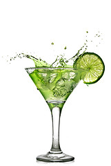 Image showing Green alcohol cocktail with splash and green lime isolated on wh