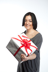 Image showing Portrait of young smiling woman with gift  on white