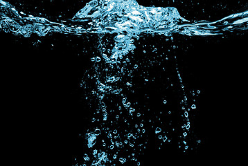 Image showing water splash with bubbles isolated on black