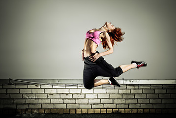 Image showing girl jumping on the roof