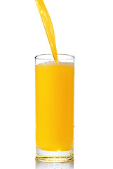 Image showing orange juice poring into glass isolated on white