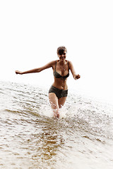 Image showing happy girl run in the water