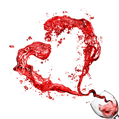 Image showing Heart from pouring red wine in glass goblet isolated on white