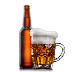 Image showing Beer in glass with water drops isolated on white 