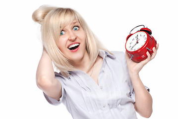 Image showing Shocked beautiful young woman with alarm clock isolated on white