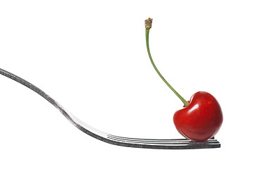 Image showing red cherry on fork isolated on white