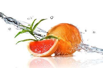 Image showing Water splash on grapefruit with mint isolated on white