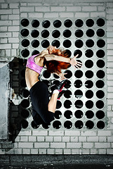 Image showing girl jumping on the roof