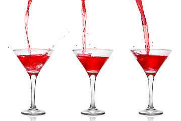 Image showing Martini cocktail with pouring into glass isolated on white